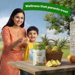 Mother giving BabyOrgano Nutriverse Immunity Gummies to child with fresh pineapple – trusted wellness for kids