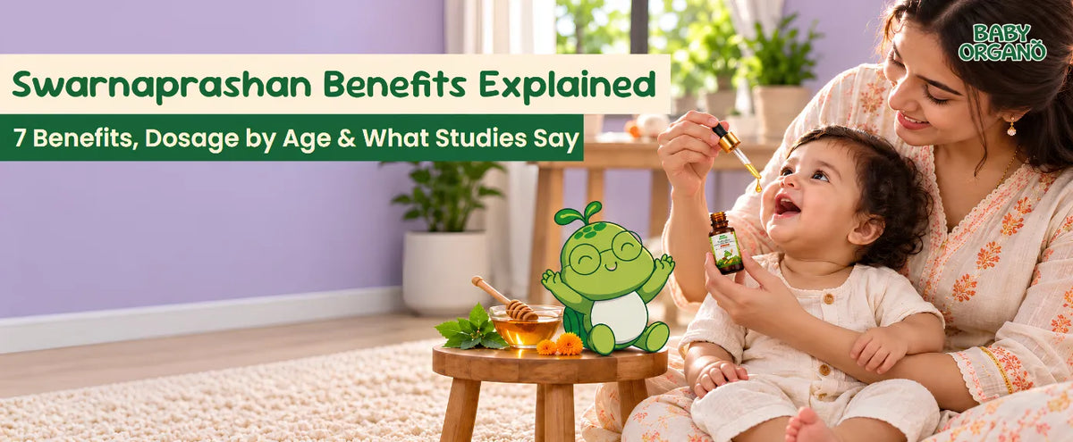 Mother administering BabyOrgano Baalprashan Swarnaprashan drops to a happy baby next to a honey bowl and Oru - green cartoon mascot.