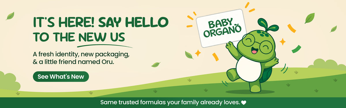 Baby Organo brand refresh announcement banner featuring green mascot Oru holding a sign alongside text introducing new packaging and identity.