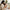 Smiling baby settled on mother's lap beside BabyOrgano Hing Tummy Roll-on