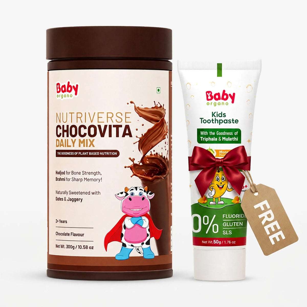 Baby Organics Nutiverse Chocovita Daily Mix powder in a brown jar alongside a tube of Kids Toothpaste with a red ribbon and a free sels tag, on a white background.