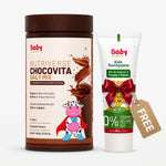 Baby Organics Nutiverse Chocovita Daily Mix powder in a brown jar alongside a tube of Kids Toothpaste with a red ribbon and a free sels tag, on a white background.